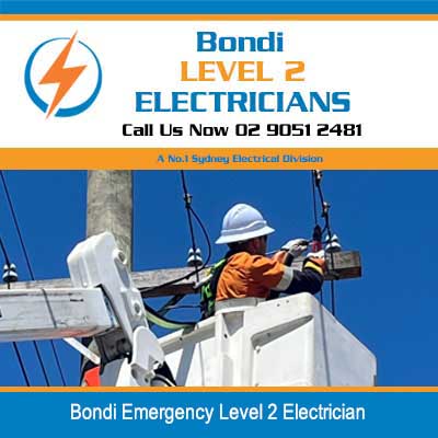 Emergency level 2 electrician in safety gear working on overhead power lines in Bondi