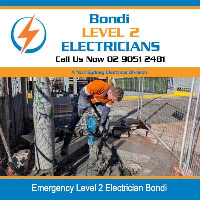 Emergency level 2 electrician in safety gear and hard hat performing underground electrical work in Bondi